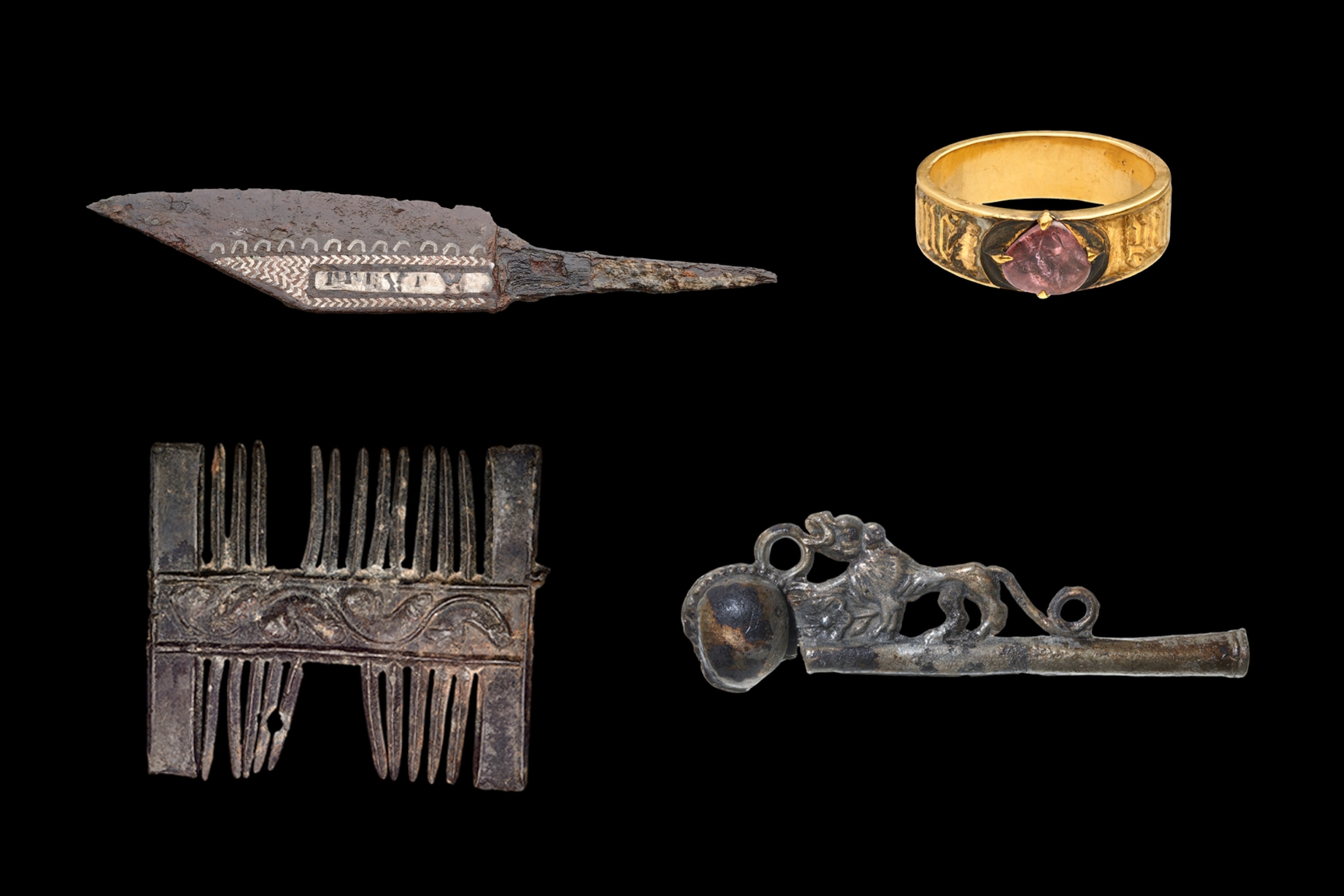 Collection of several object displayed on black background, including: 16th-century whistle used on ships, 15th-century gold ring with pink gemstone, viking-era iron dagger, medieval pilgrim’s badge.