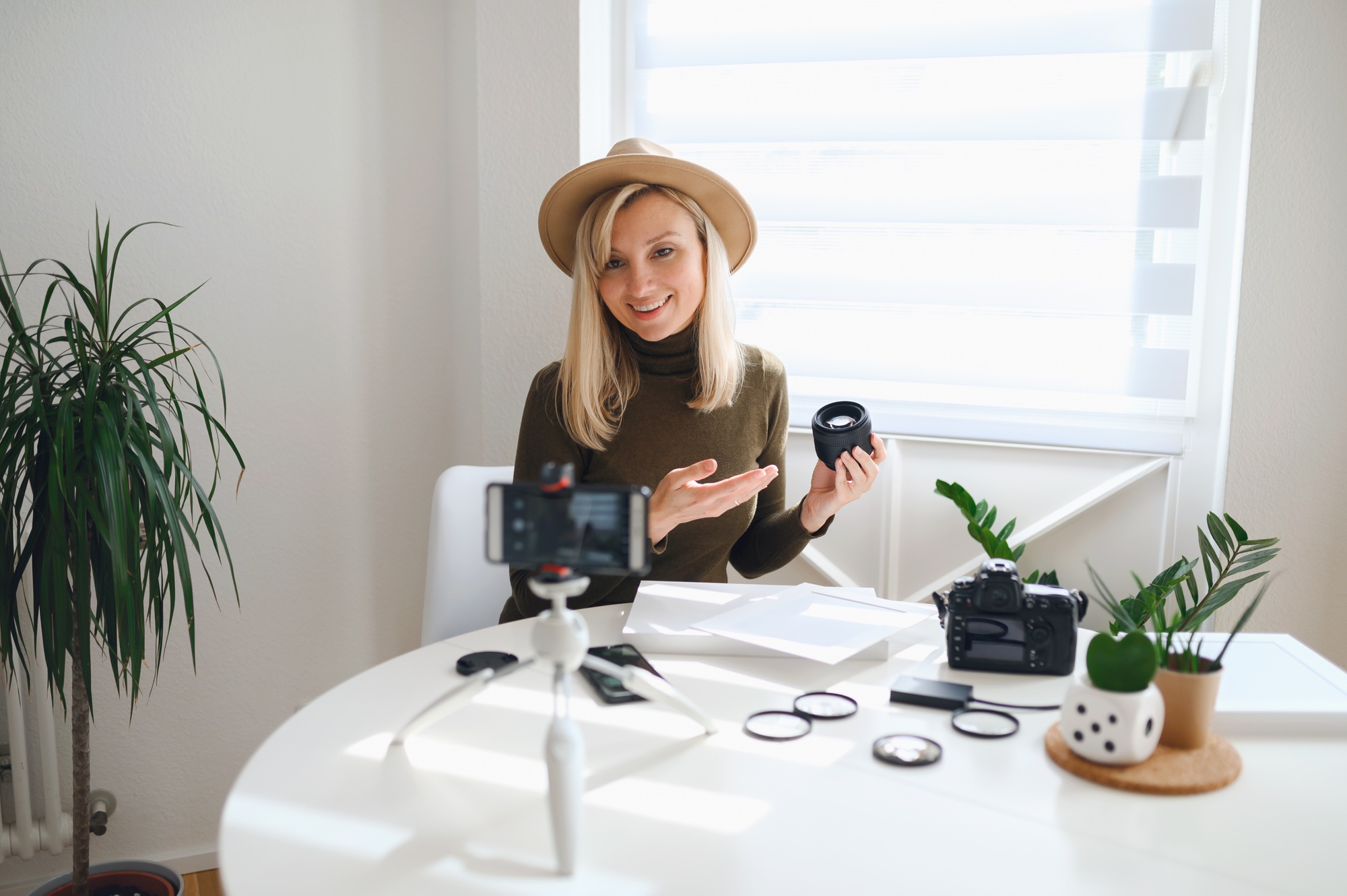 Girl photographer freelancer shows photo equipment live online