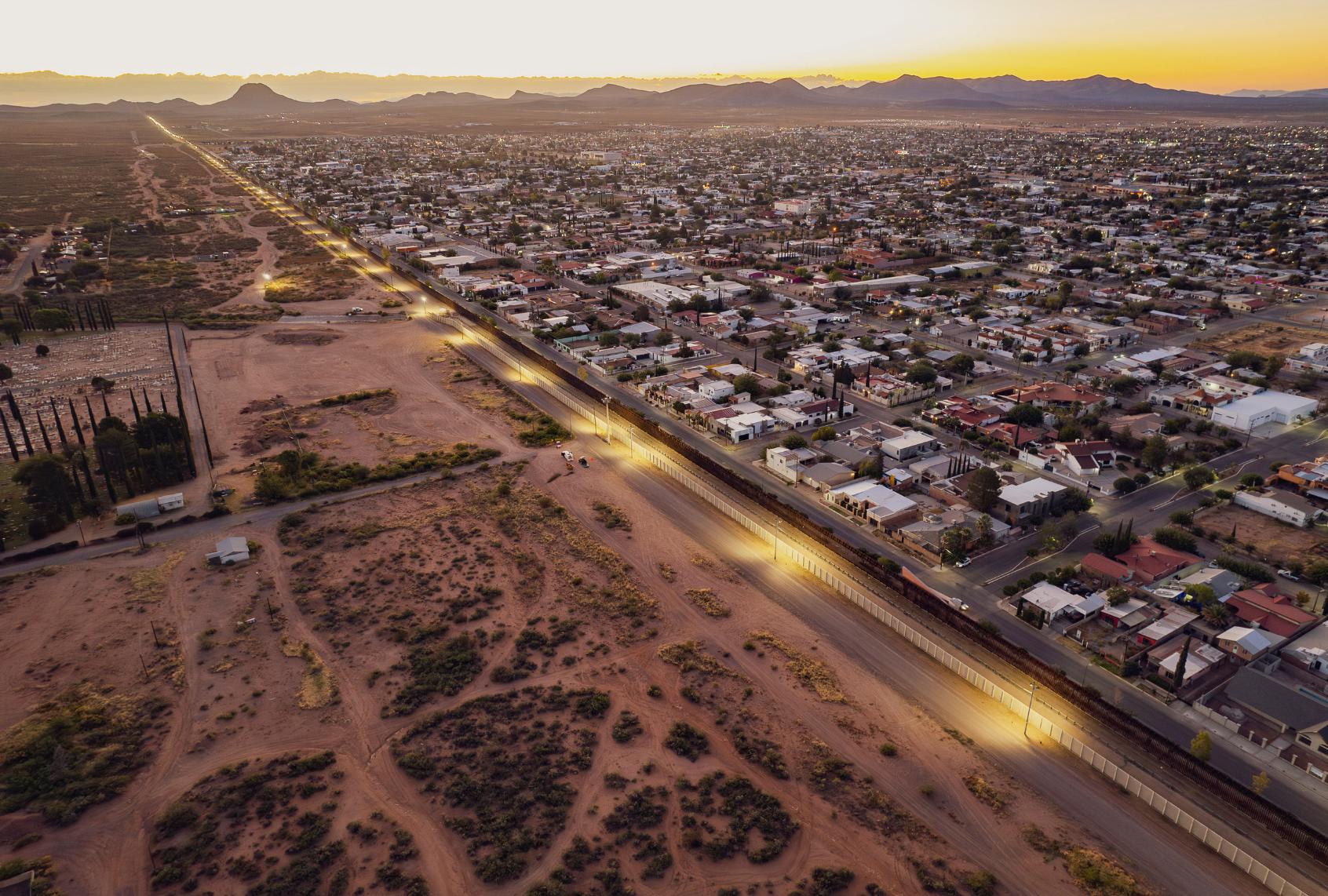 An aerial view shows the south side of the city of Douglas next to the double wall on the US-Mexico next to the Mexican city of Agua Prieta (L) in Douglas, Arizona, on October 15, 2024. (OLIVIER TOURON/AFP via Getty Images)