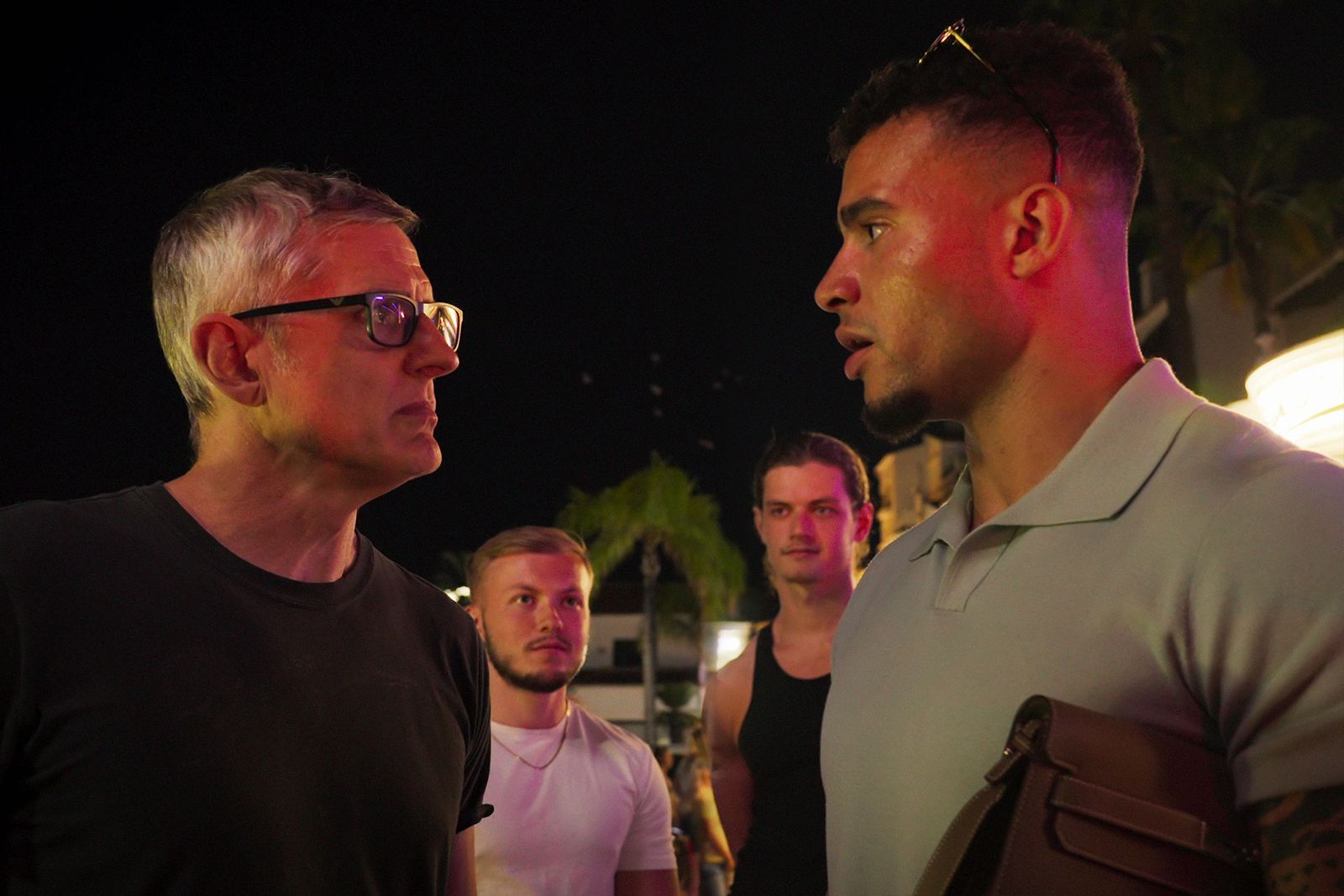 Image may contain Rami Malek Lighting Face Head Person Photography Portrait Clothing TShirt Urban and Adult